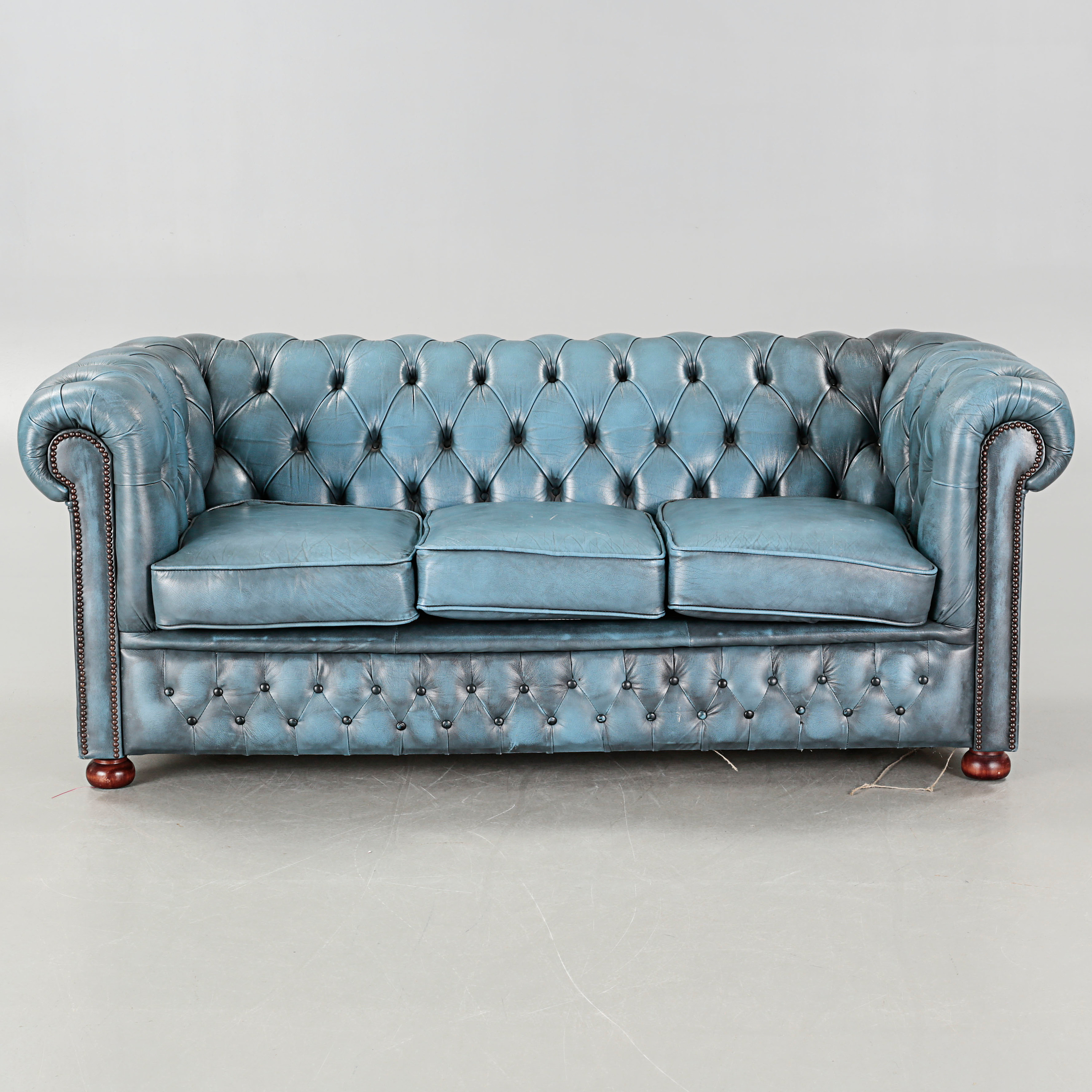 A sofa in Chesterfield style, made by Winchester Furniture in the