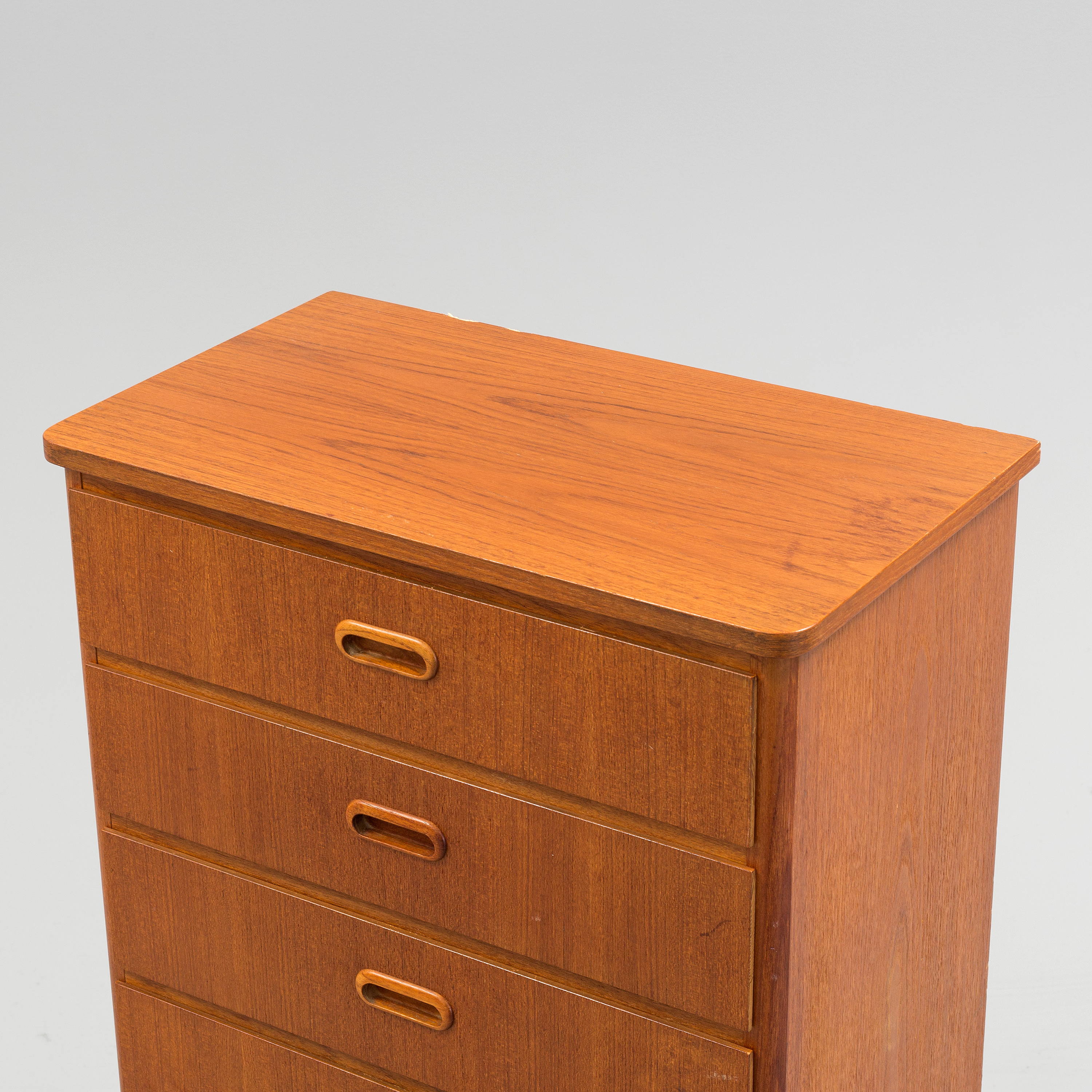 A teak veneered chest of drawers, 1950's/60's. Bukowskis