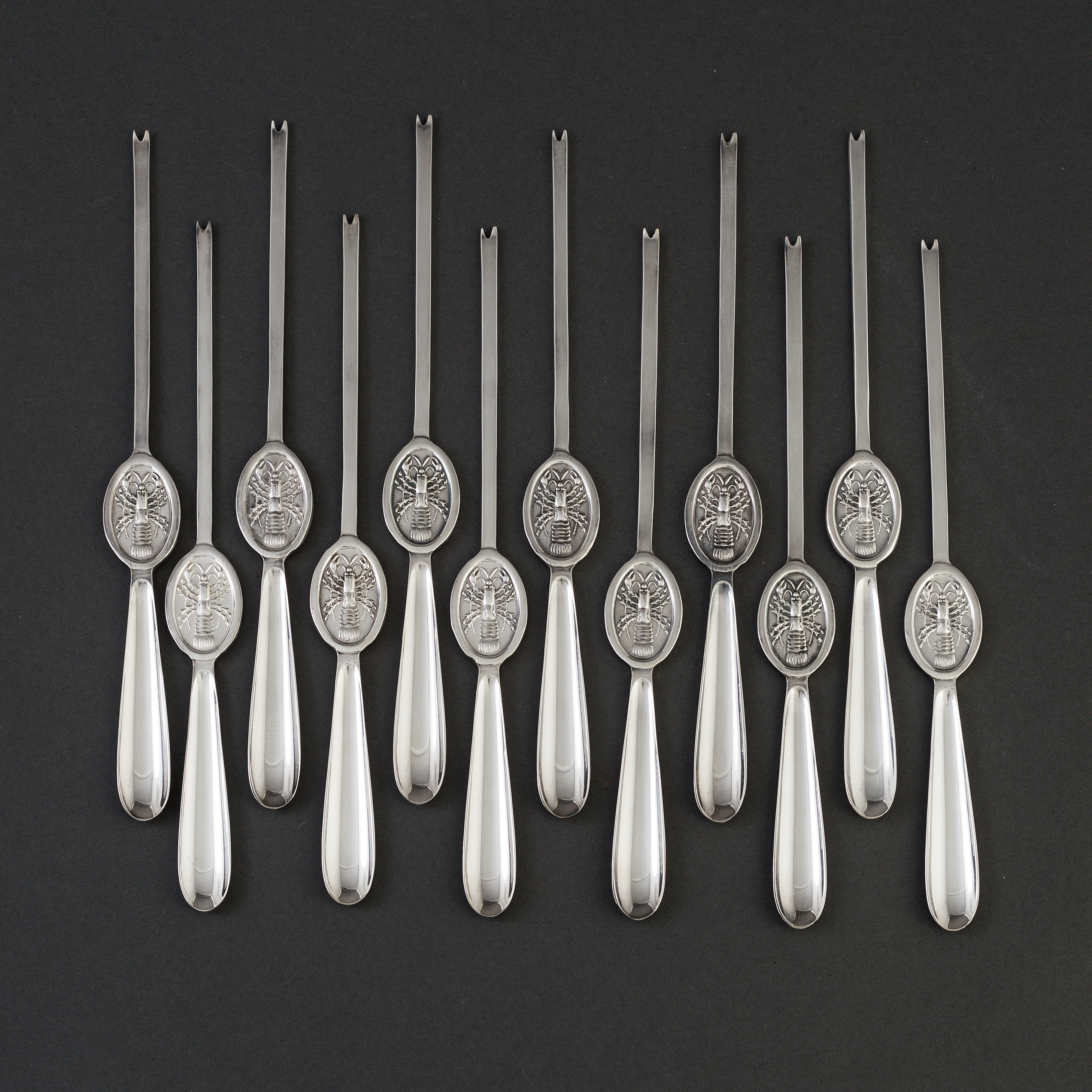 12 silver plate lobster forks. Bukowskis