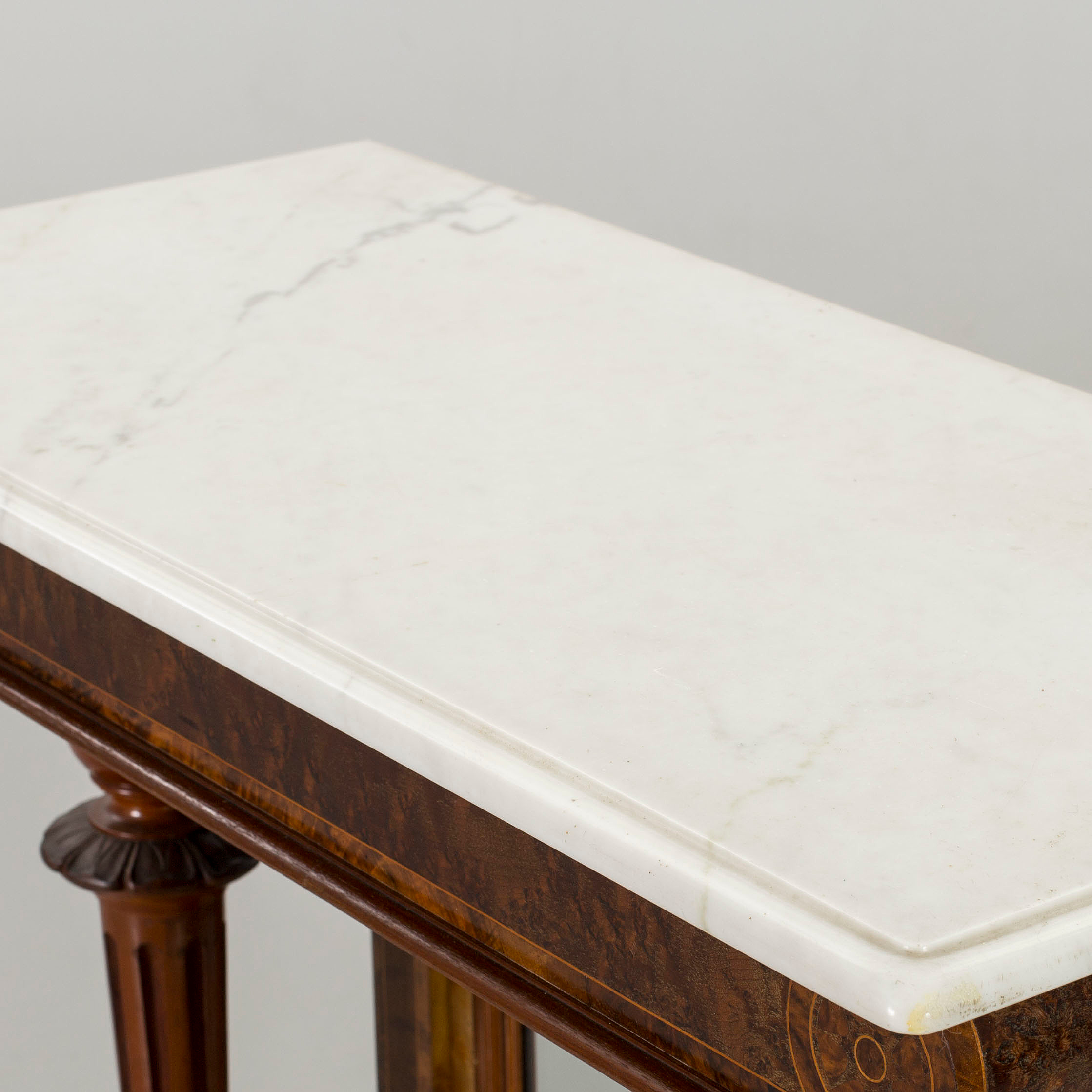 A walnut wall table with white marble top, late 19th or early 20th century.  - Bukowskis