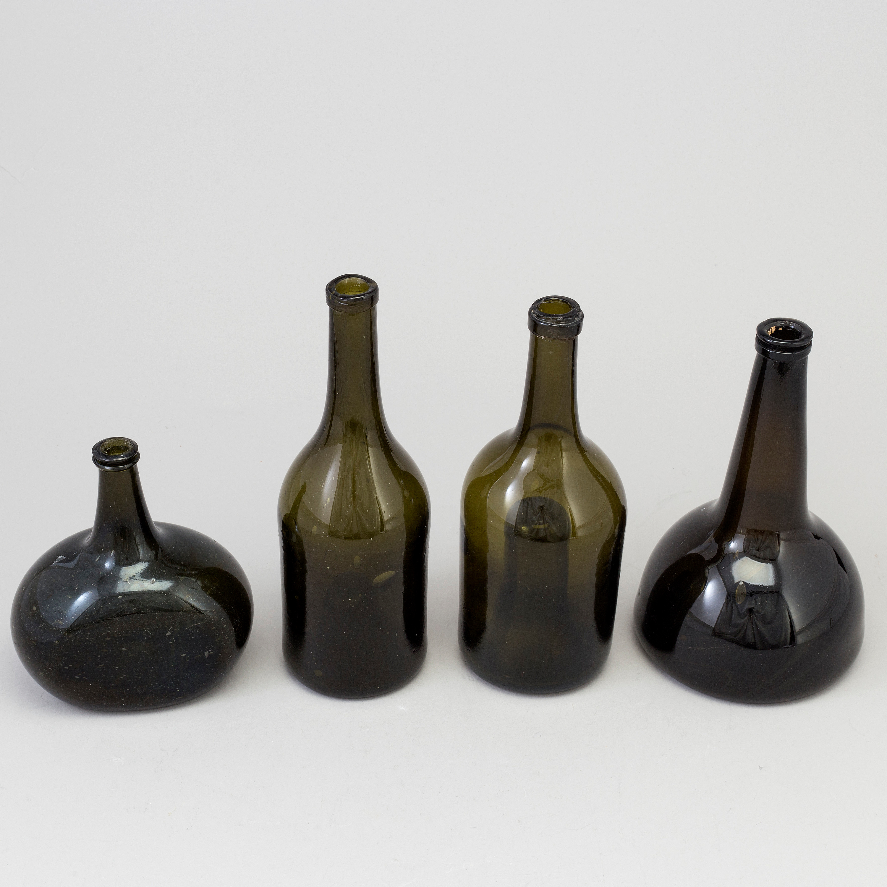 A set of four 18th/19th century hand blown glass bottles. Bukowskis