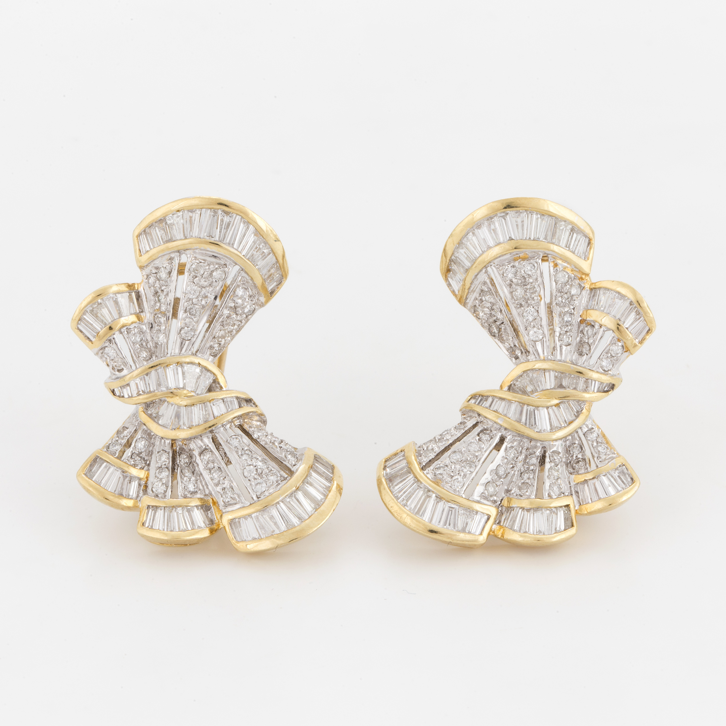 A pair of earrings in the shape of bows set with round, brilliant and