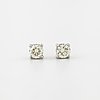 A pair of brilliant cut diamond earrings.