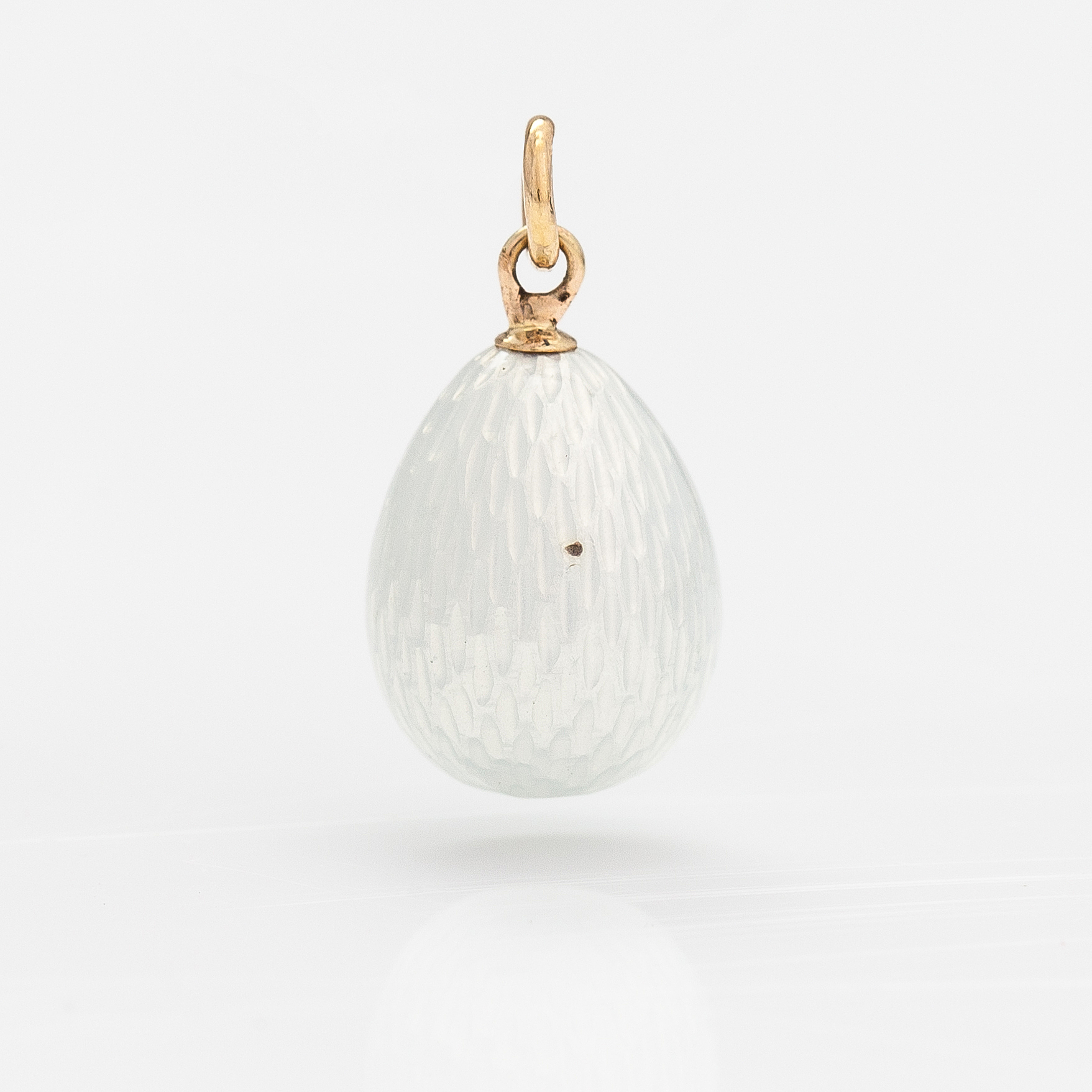 A silver, 14K gold and enamel egg shaped pendant. Bukowskis