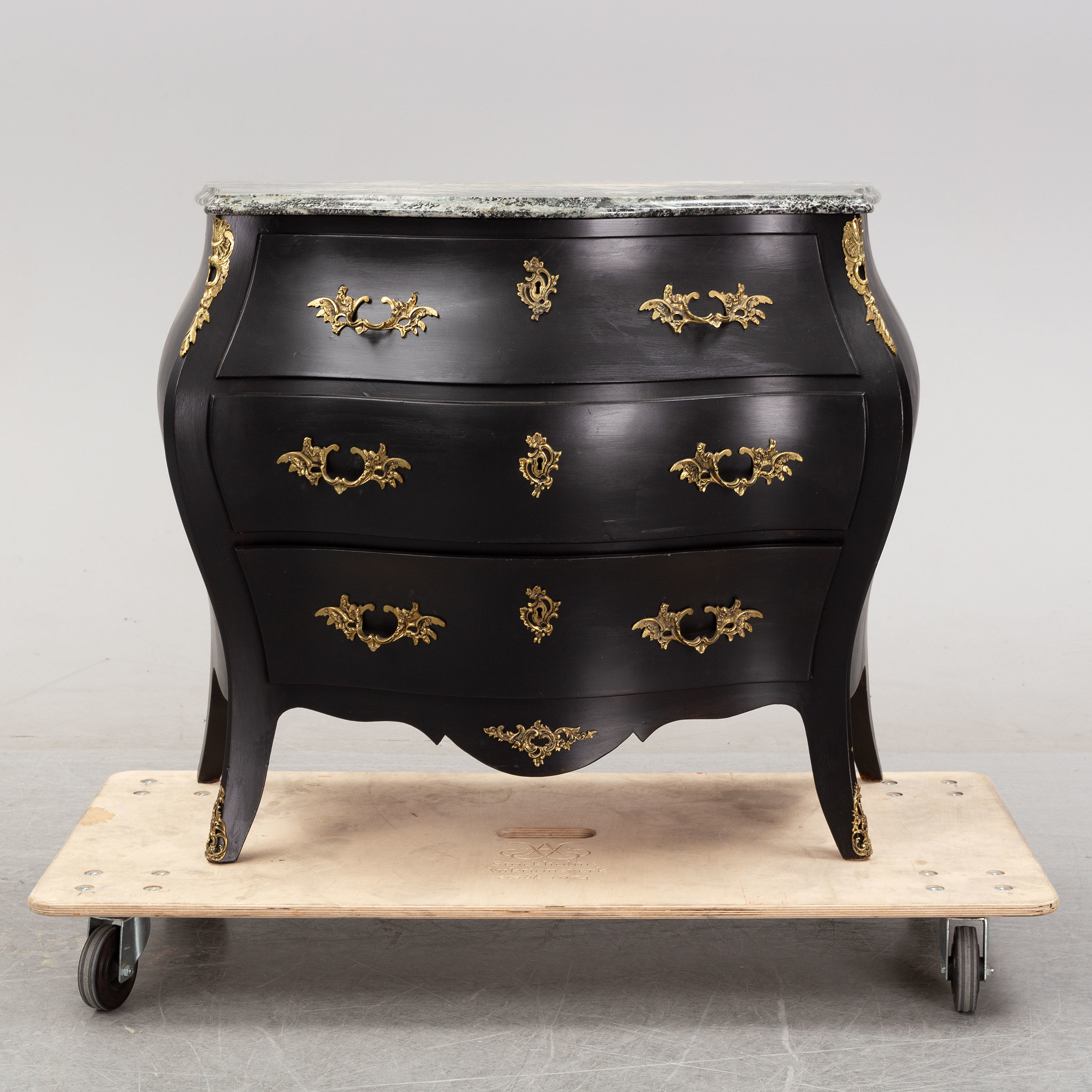 A Rococo style stone top chest of drawers, mid 20th Century. Bukowskis