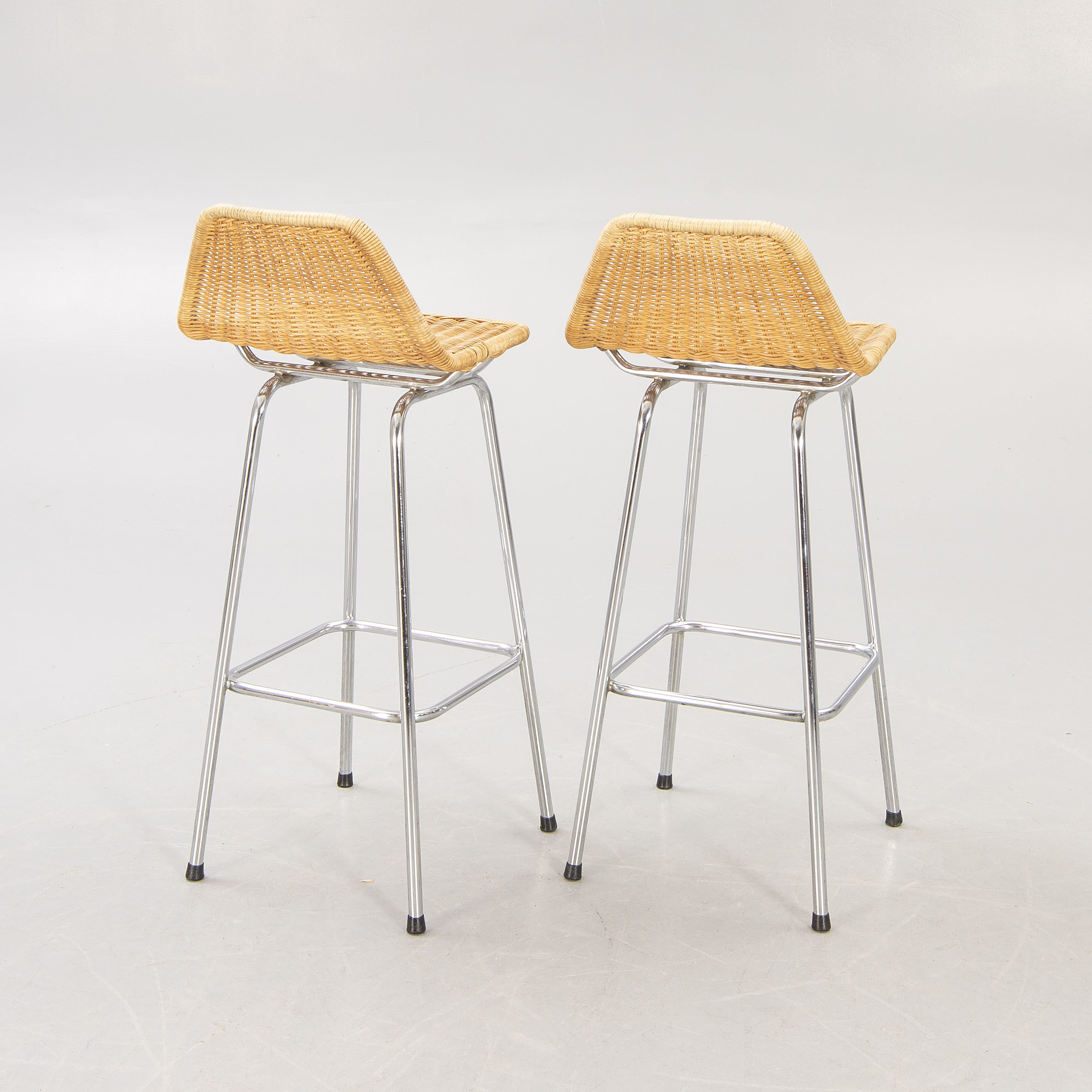 A pair of metal and rattan bar stools, last part of the 20th century