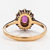 An 18K gold ring with diamonds ca. 0.24 ct in total and a ruby.
