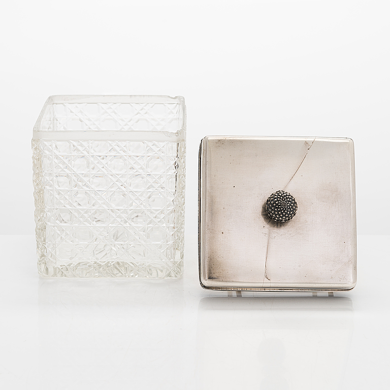 K. Fabergé, a pair of cut-glass toilette boxes in silver stand, Imperial Warrant mark, Moscow 1896.