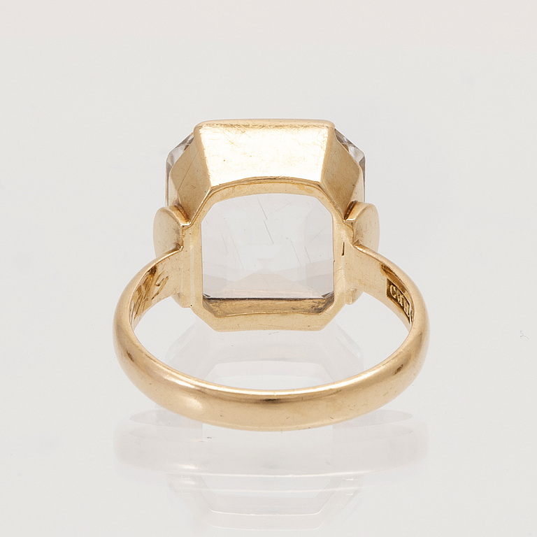 A set of 18K gold earrings and ring with faceted rock quartz crystal.