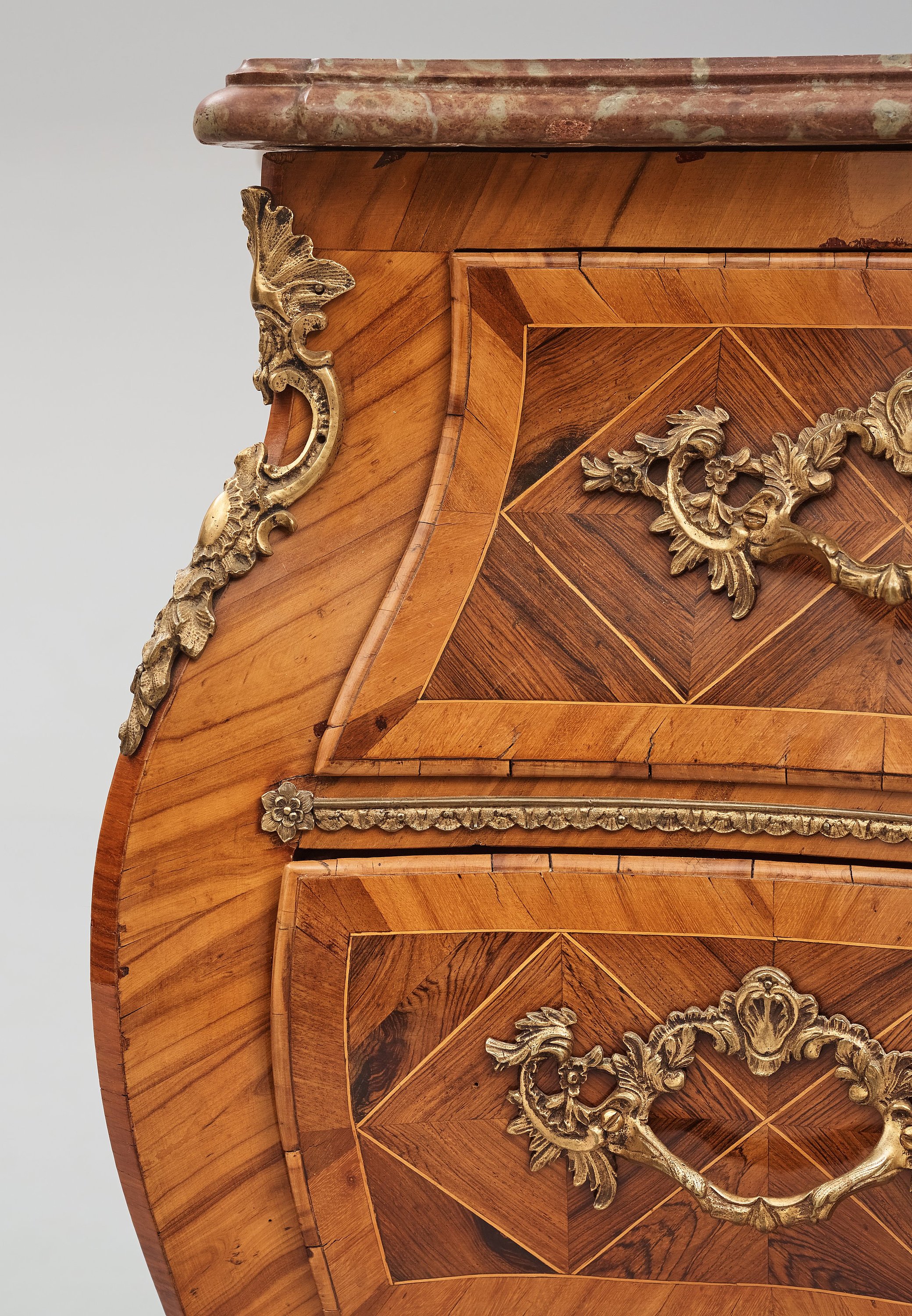 A rosewoodveneered and ormolumounted Rococo chest of drawers by J