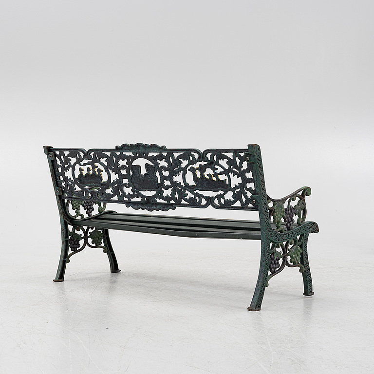 A children's cast iron garden sofa and armchair, mid 20th century.