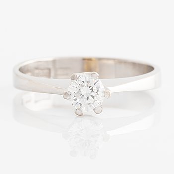 Ring solitaire with brilliant-cut diamond.