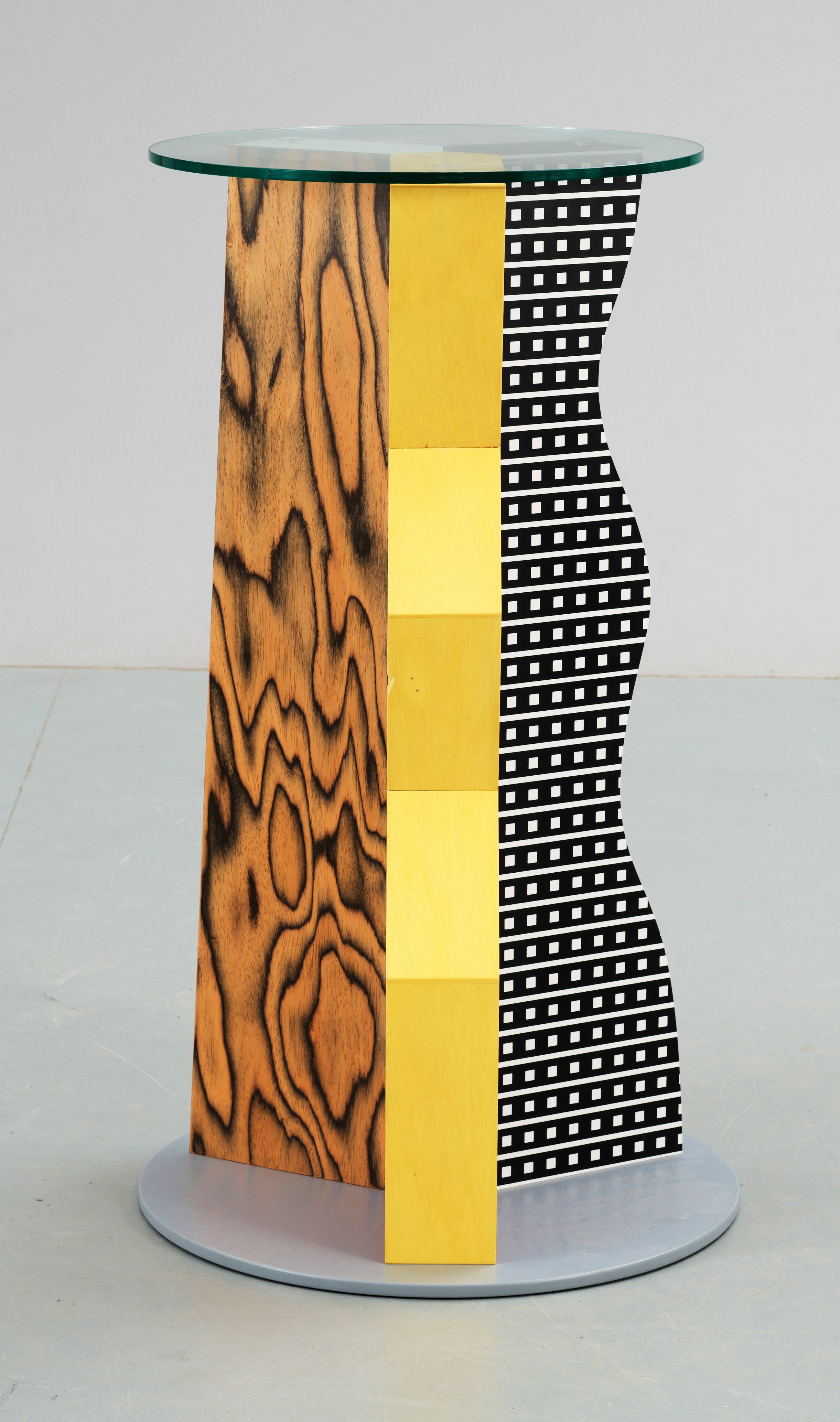 An Ettore Sottsass 'Ivory' glass and plastic laminate occasional table, Memphis, Italy. Bukowskis