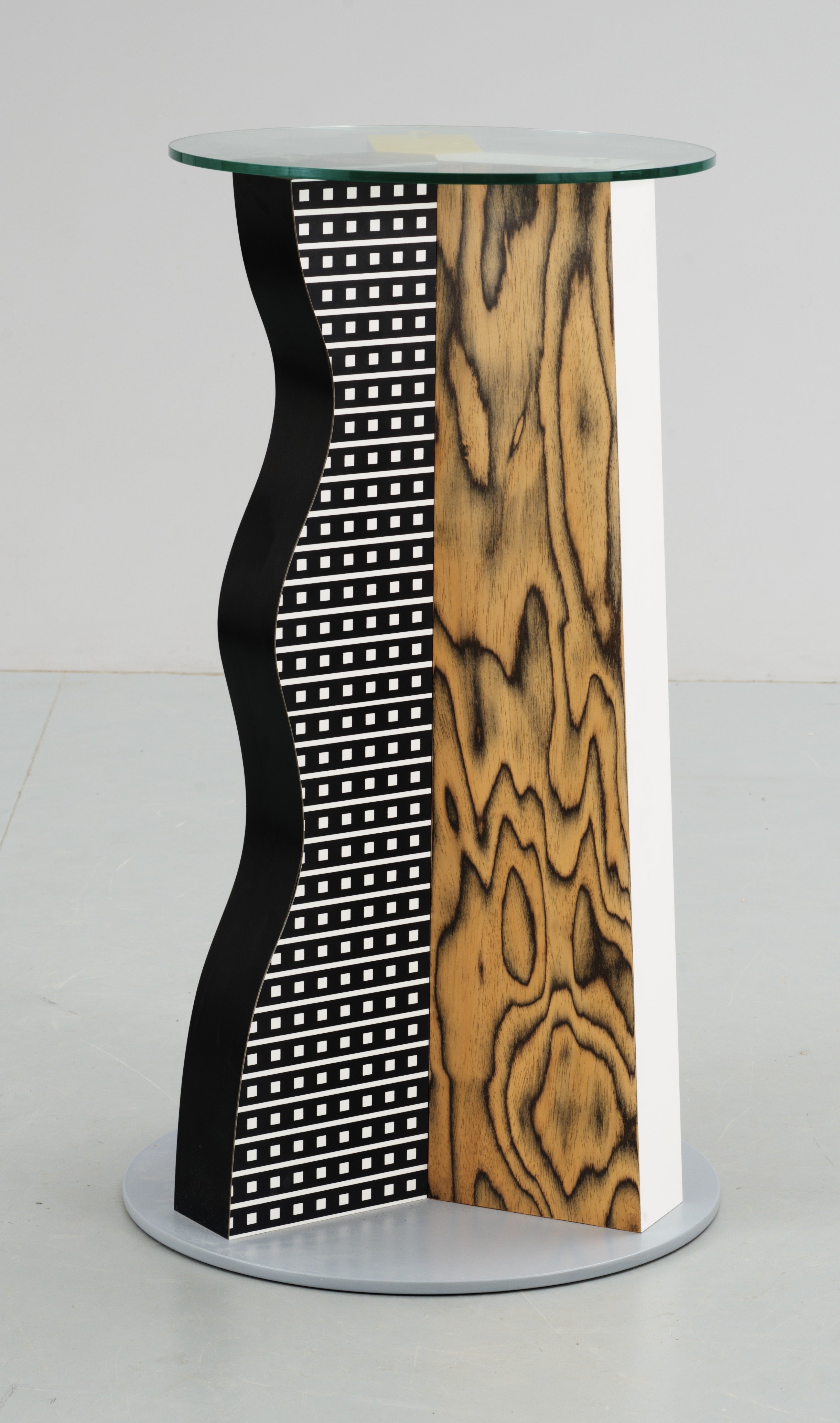 An Ettore Sottsass 'Ivory' glass and plastic laminate occasional table, Memphis, Italy. Bukowskis