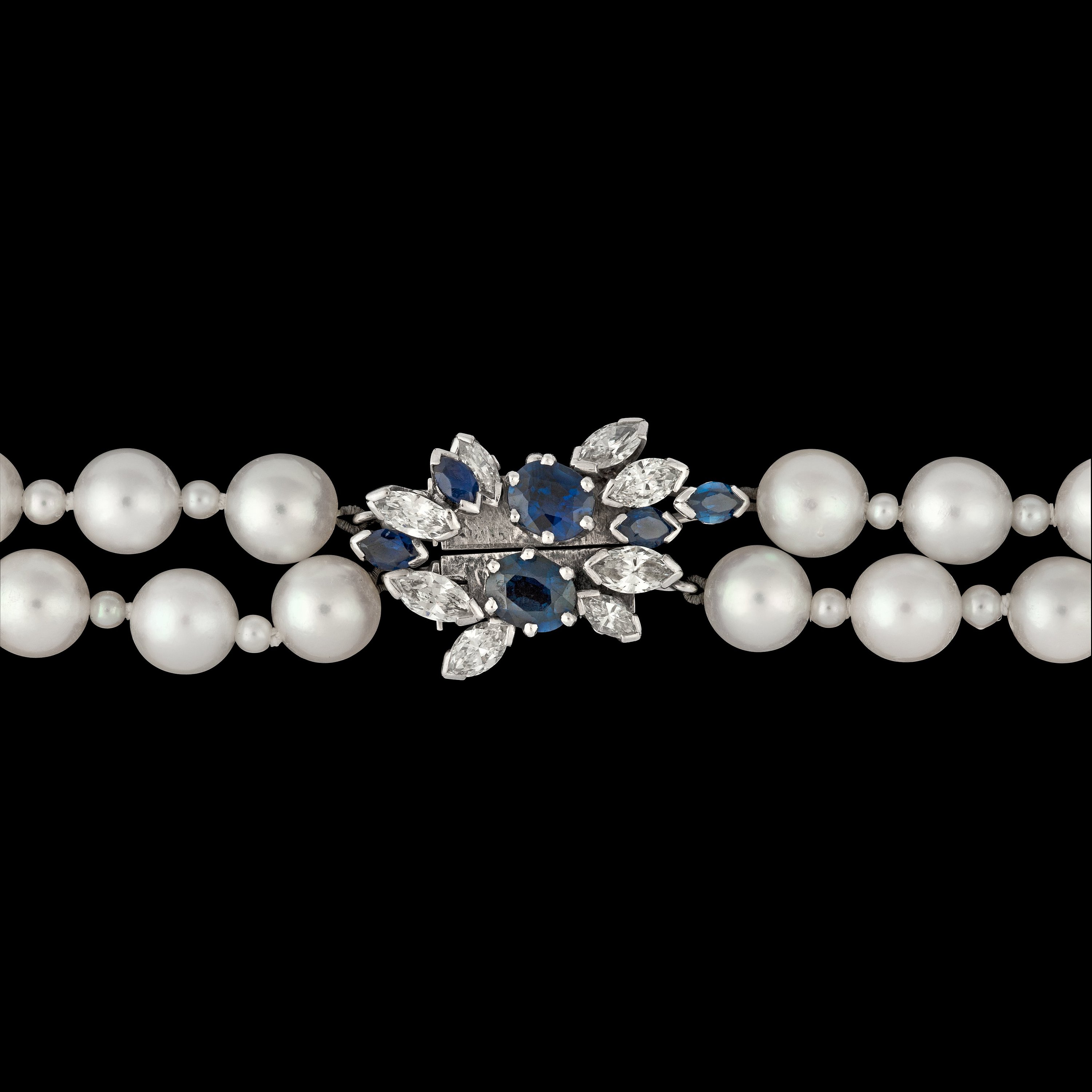 A two strand cultured pearl necklace, 6,8 mm, with blue sapphire and diamond clasp. Bukowskis