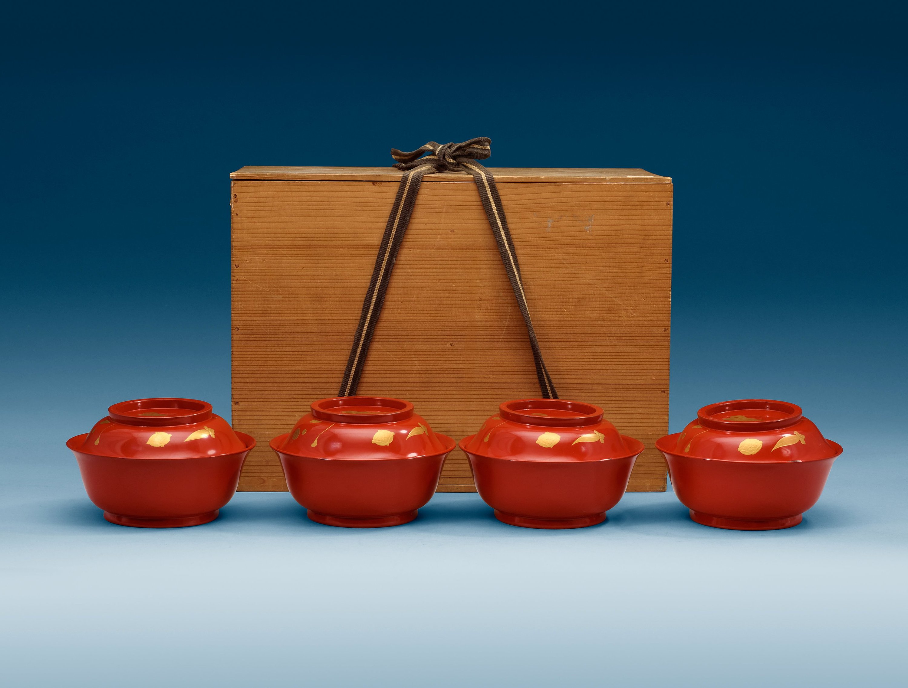 A set of eight red lacquered Japanese bowls with covers, first half of
