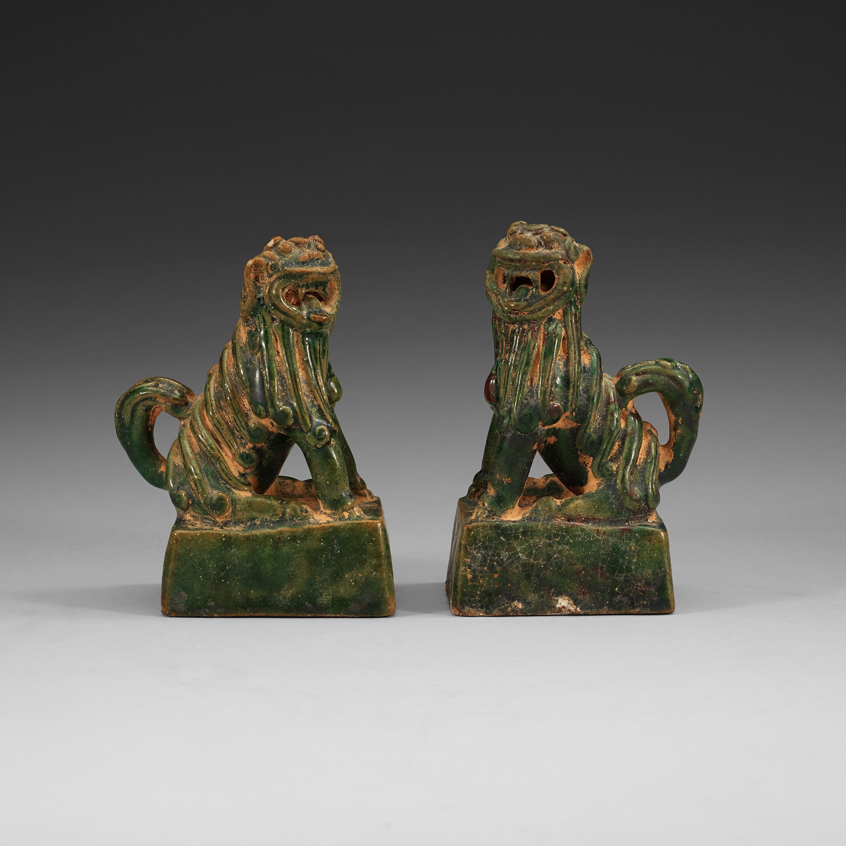 A pair of green glazed joss stick holders, Ming dynasty (13681644