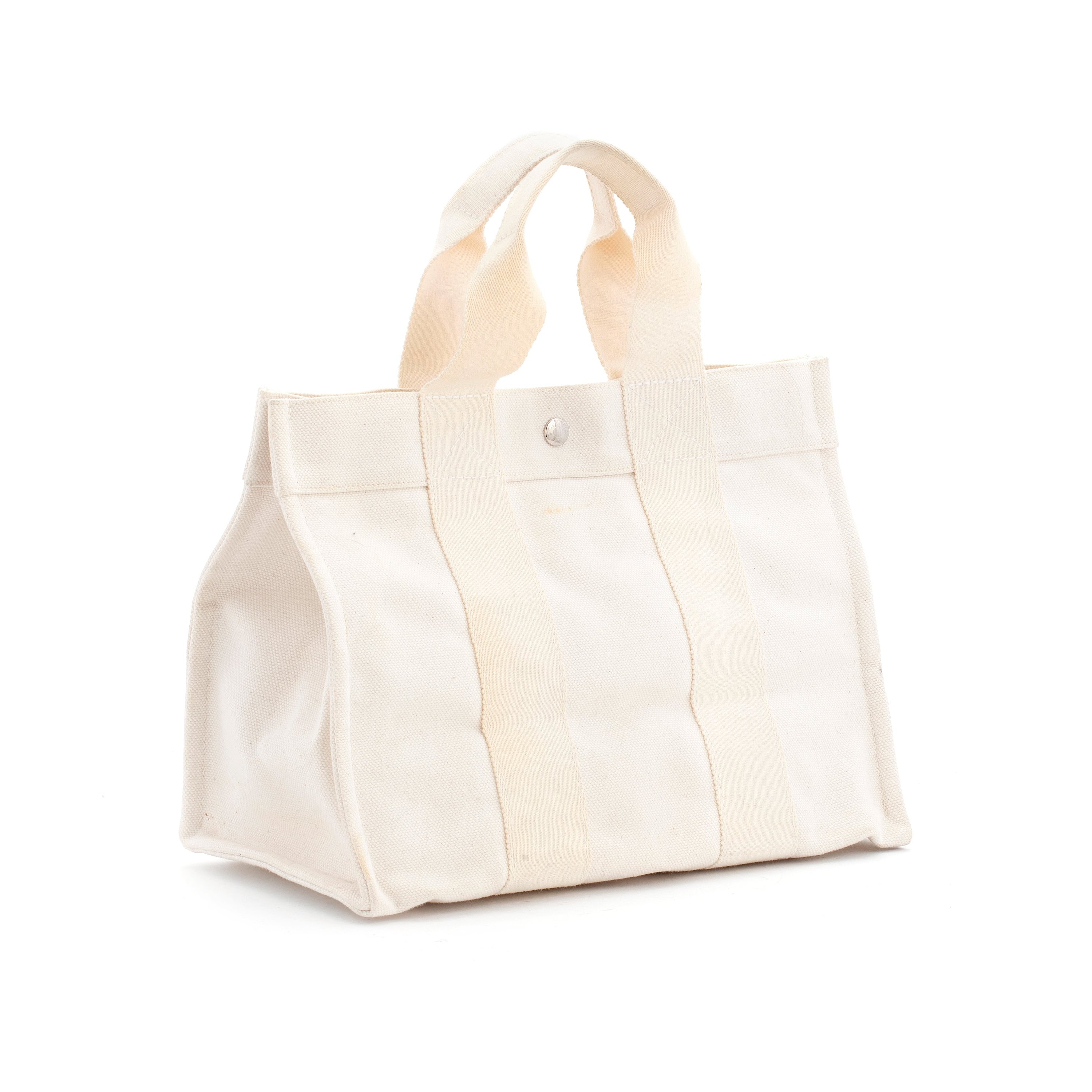 HERMÈS, a white canvas handbag. Bukowskis