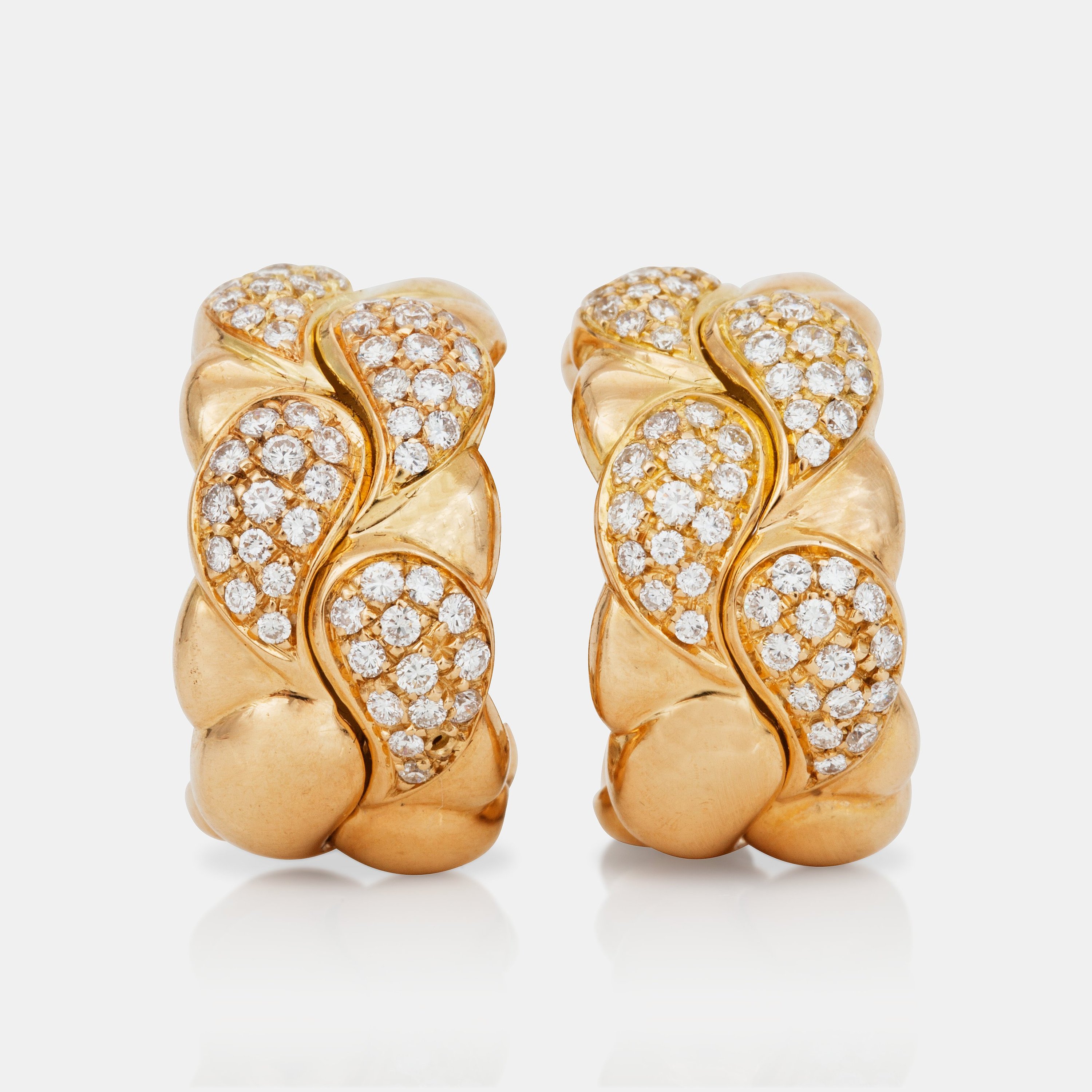 A pair of Chopard 'Casmir' brilliantcut diamond earrings. Total carat