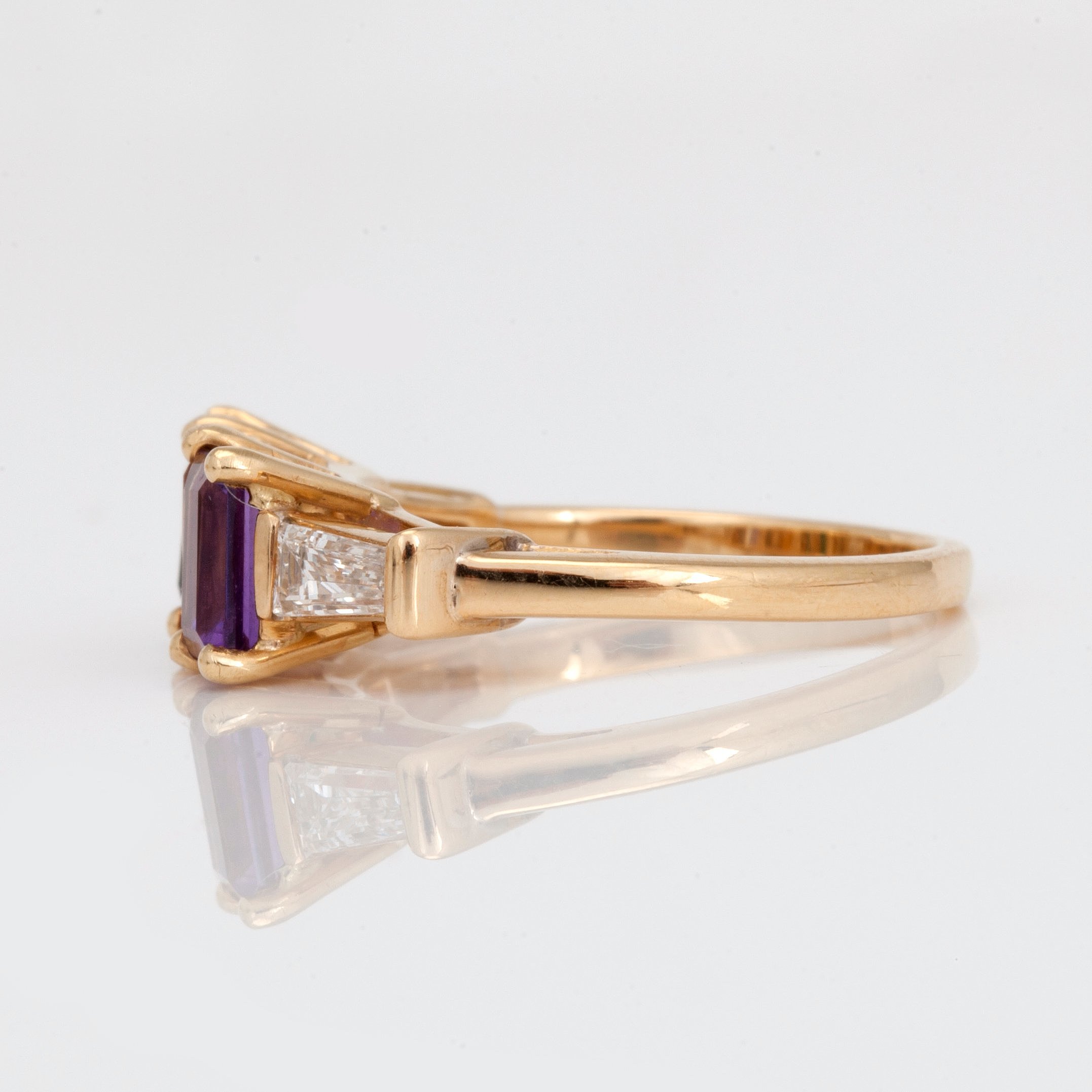 A stepcut tourmaline, amethyst, citrine and trapezecut diamond ring
