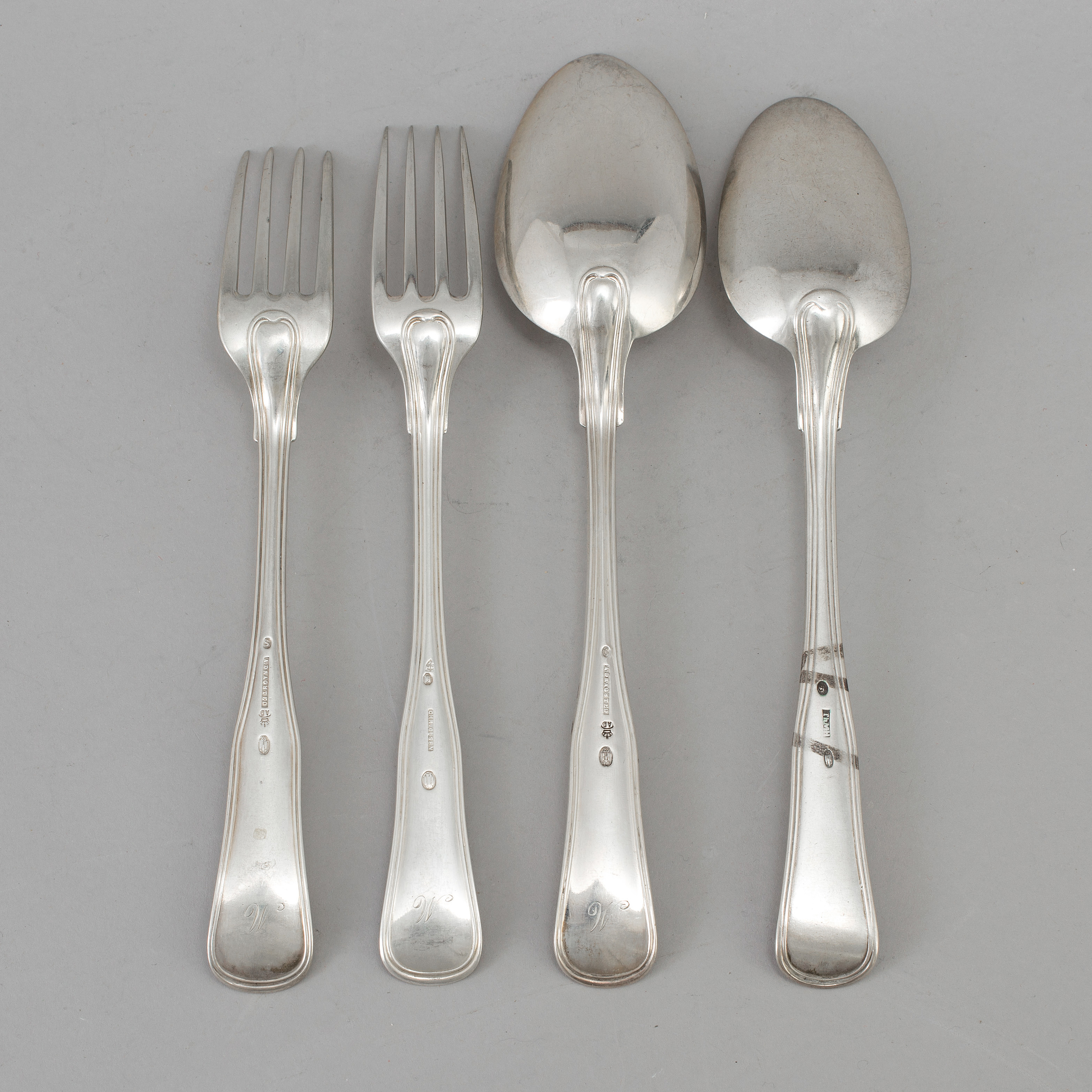 A set of twelve forks and four spoons, silver, maker's mark Arendt