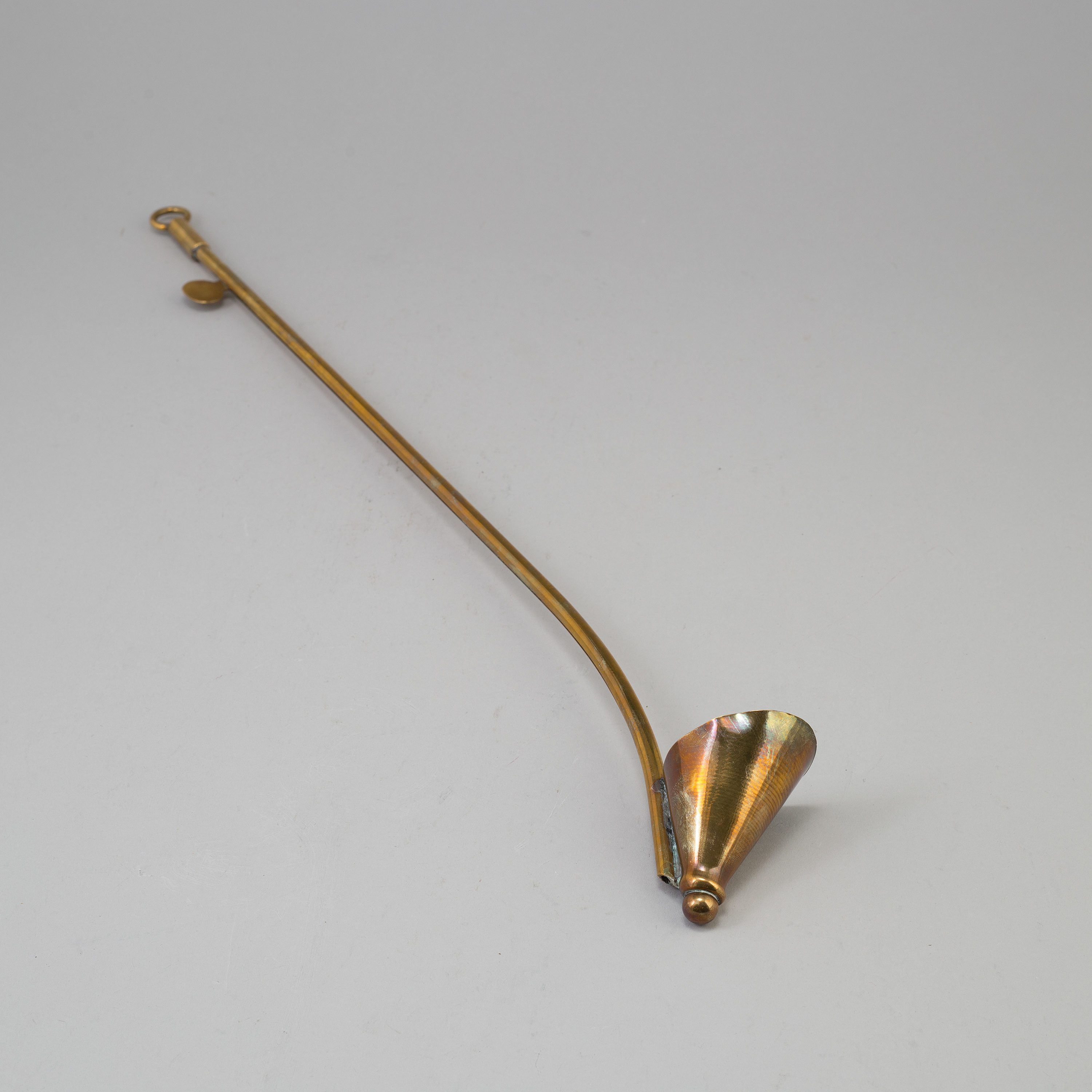 A BRASS CANDLE SNUFFER/LIGHTER, 19th century. Bukowskis