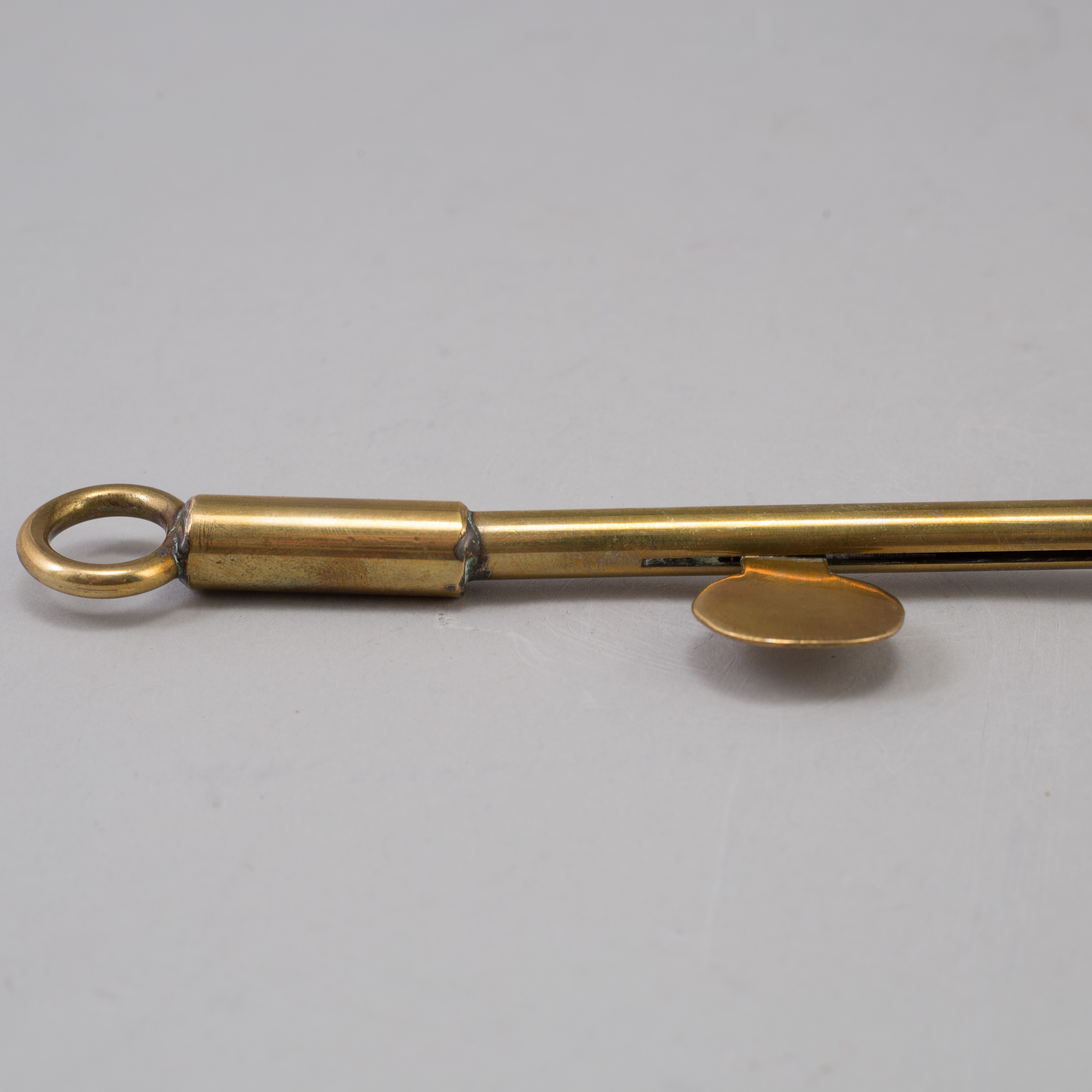 A BRASS CANDLE SNUFFER/LIGHTER, 19th century. Bukowskis