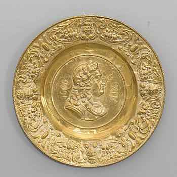 A BRASS PLATE, around the year 1900.