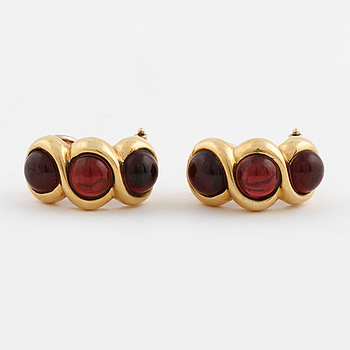 A pair of cabochon cut garnets earrings from Milano, Italy.