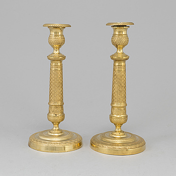 A pair of Empire gilt bronze candlesticks, first half of the 19th Cetury.