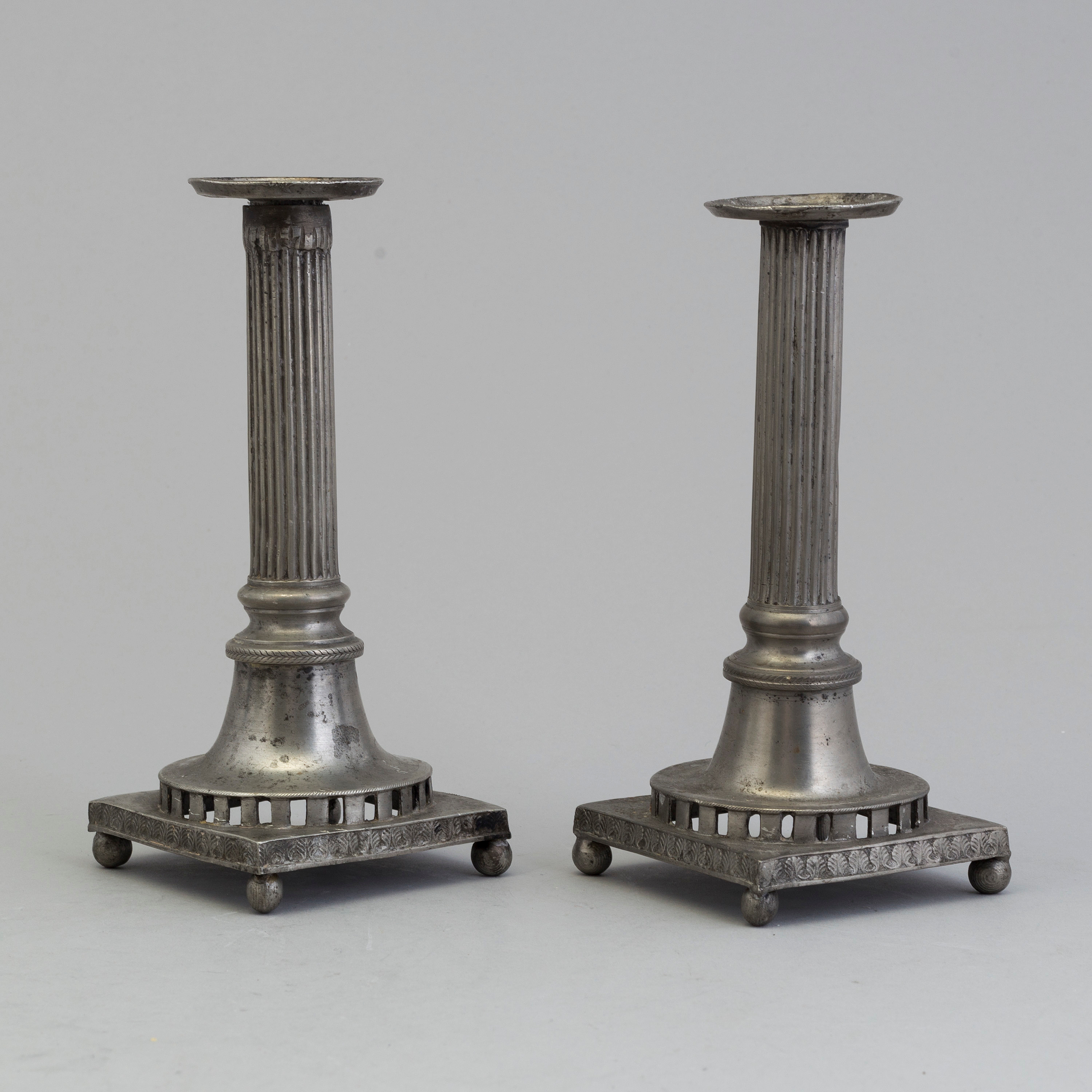 A pair of pewter candle holders by Nils Justelius, Eksjö, Sweden, 1842