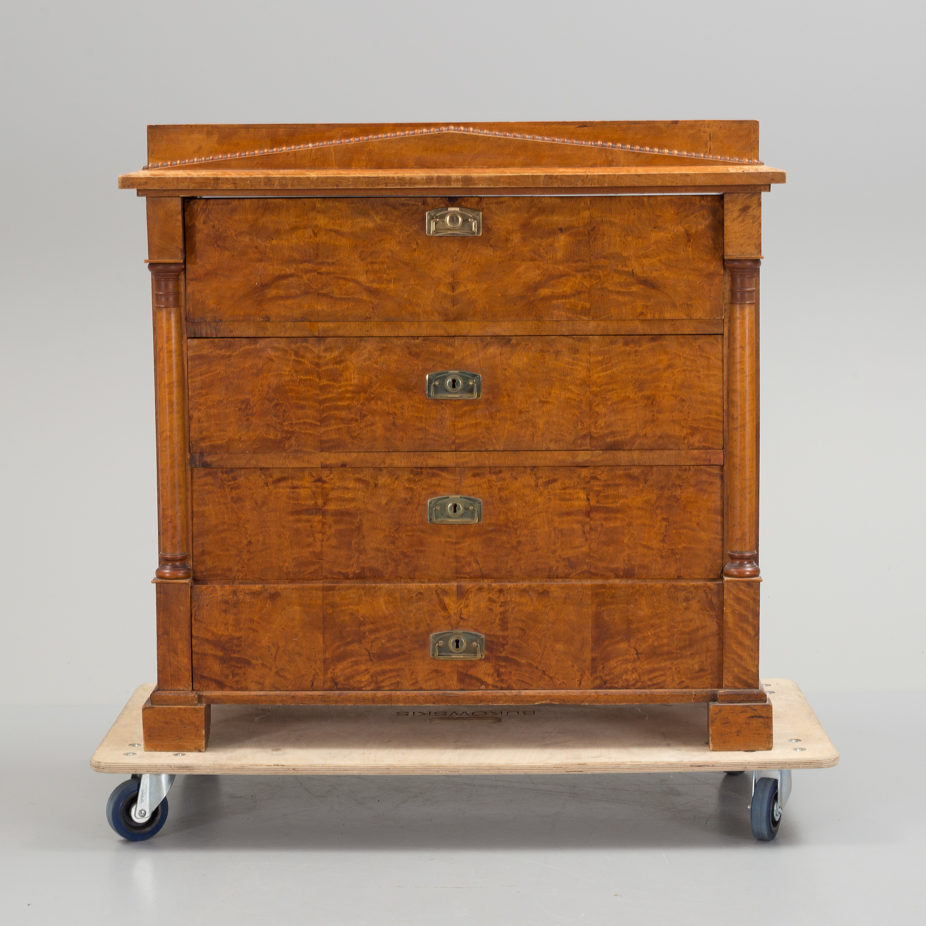 A mid 19th century birch veneered chest of four drawers. Bukowskis