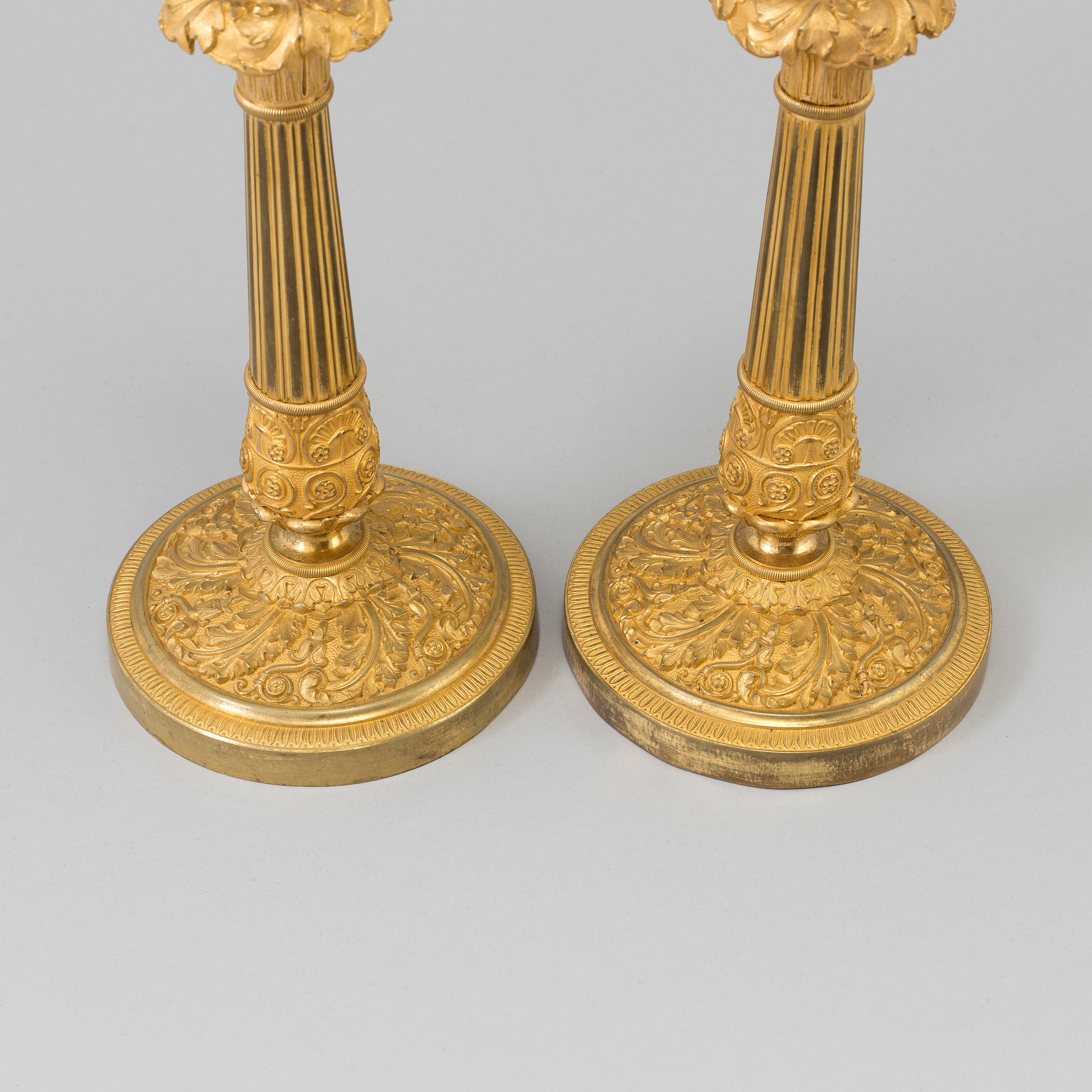 A pair of Empire gilt bronze candlesticks, first half of the 19th