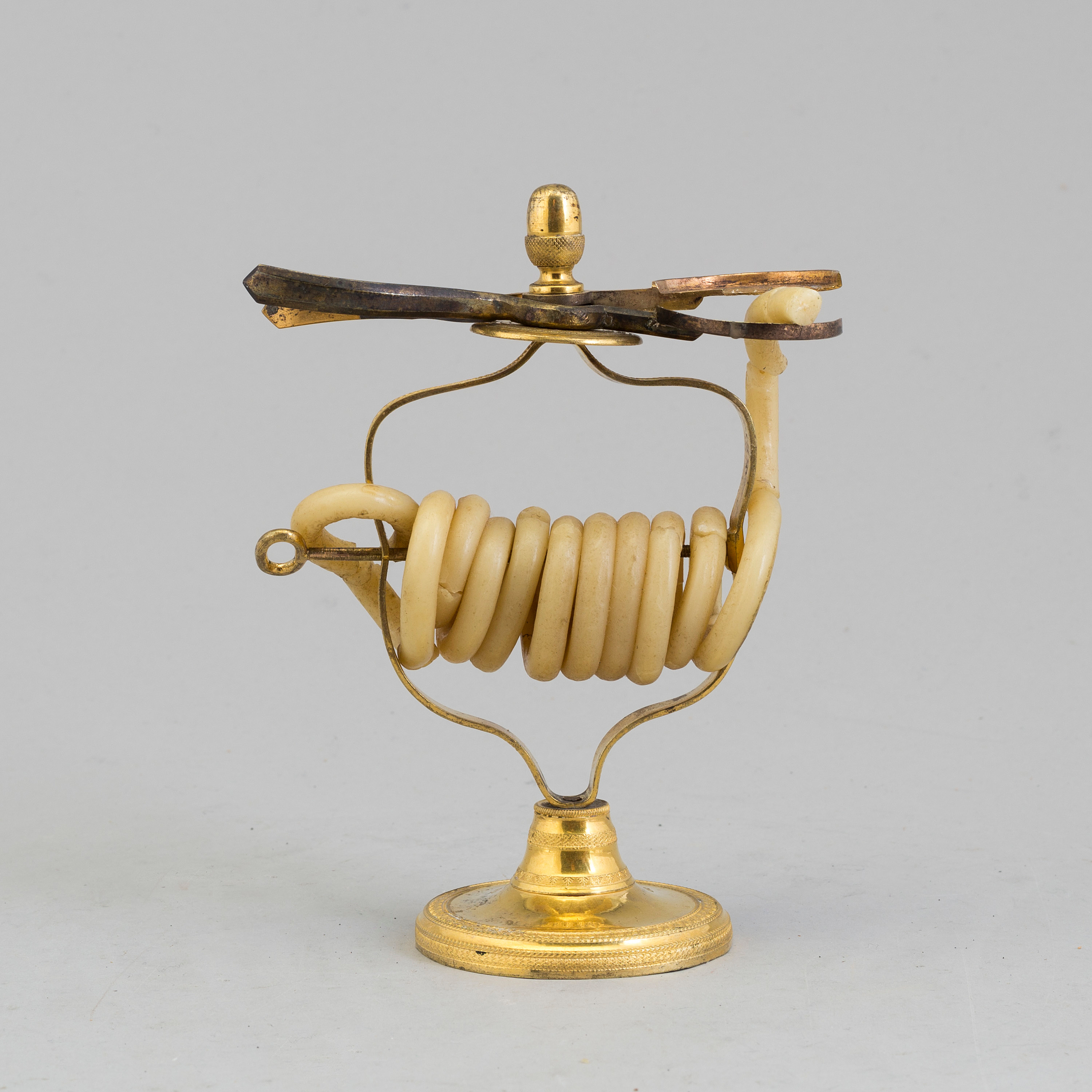 An early 19th century gilt brass candle / candle cutter. Bukowskis